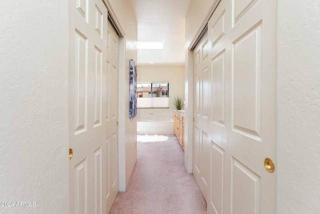 corridor with light colored carpet