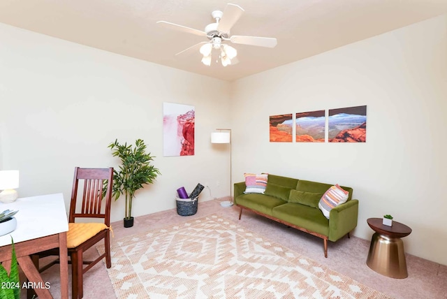 living area with light carpet and ceiling fan