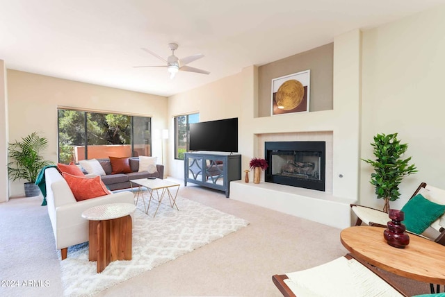 living room with a healthy amount of sunlight, ceiling fan, and light colored carpet