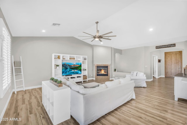 18822 E Flintlock Dr, Queen Creek, AZ 85142 - living room with a fireplace, light wood-style flooring, a ceiling fan, lofted ceiling, and visible vents
