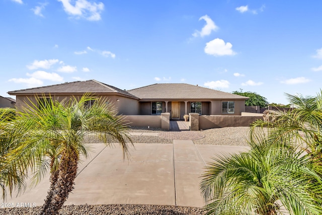 18822 E Flintlock Dr, Queen Creek, AZ 85142 - view of front of home with fence private yard, stucco siding, and driveway