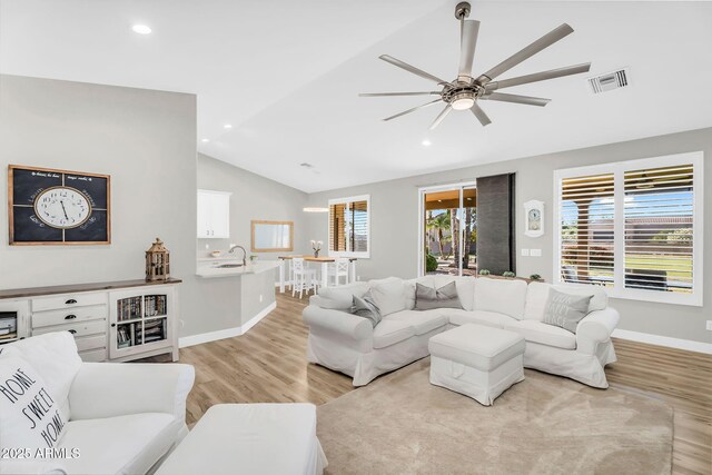 18822 E Flintlock Dr, Queen Creek, AZ 85142 - living area featuring light wood finished floors, a ceiling fan, baseboards, lofted ceiling, and visible vents