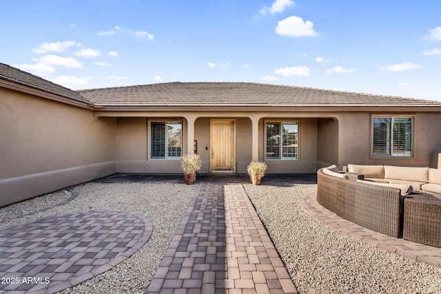 18822 E Flintlock Dr, Queen Creek, AZ 85142 - entrance to property featuring a patio, an outdoor hangout area, and stucco siding