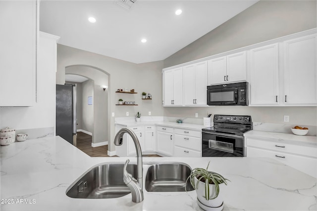 18822 E Flintlock Dr, Queen Creek, AZ 85142 - kitchen featuring arched walkways, a sink, black appliances, and white cabinetry