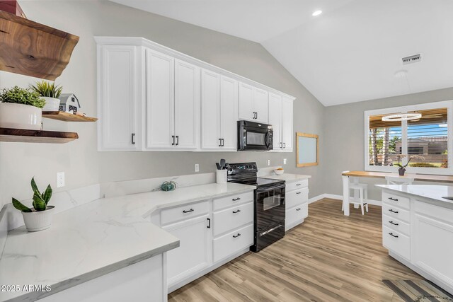 18822 E Flintlock Dr, Queen Creek, AZ 85142 - kitchen with visible vents, vaulted ceiling, white cabinets, black appliances, and light wood-style flooring