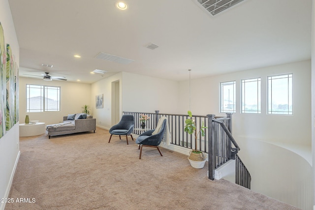 sitting room featuring recessed lighting, carpet flooring, an upstairs landing, and visible vents