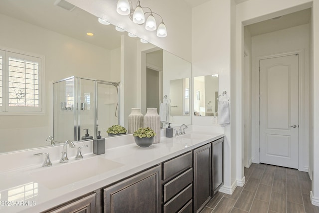 bathroom with a sink, double vanity, a chandelier, and a shower stall