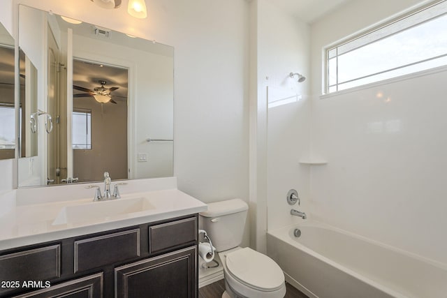 full bathroom with vanity, visible vents, ceiling fan, bathtub / shower combination, and toilet