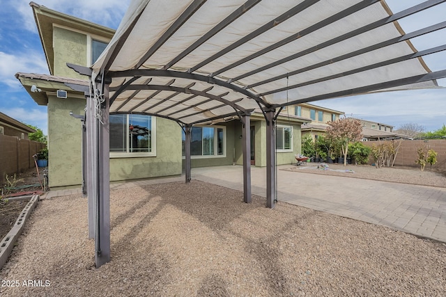 exterior space with a pergola and fence