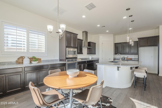 dining room featuring an inviting chandelier, recessed lighting, visible vents, and wood tiled floor