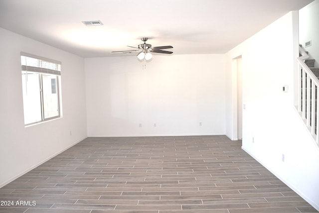 empty room featuring ceiling fan and dark hardwood / wood-style flooring