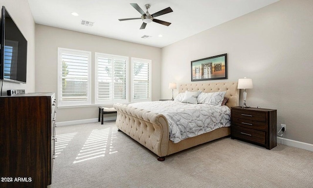 bedroom with ceiling fan and light carpet