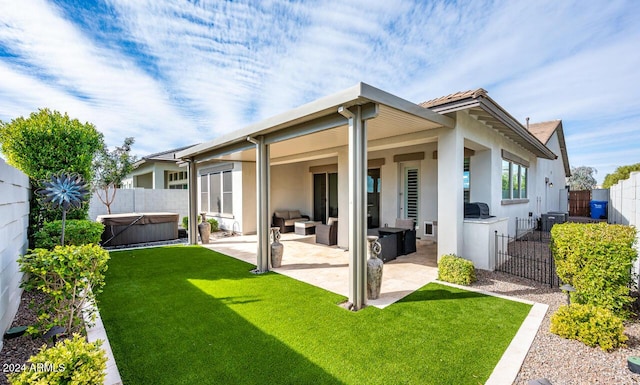 back of house featuring a lawn, an outdoor living space, cooling unit, a patio, and a hot tub