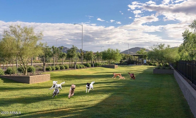 surrounding community featuring a mountain view and a yard