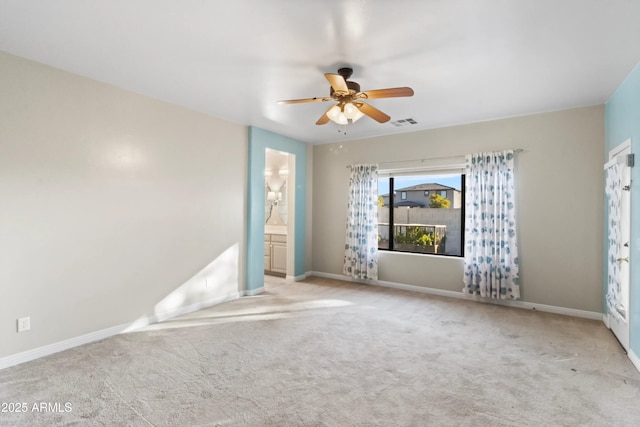 spare room with ceiling fan and light carpet