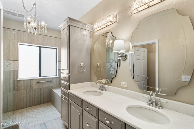 bathroom with a chandelier and vanity