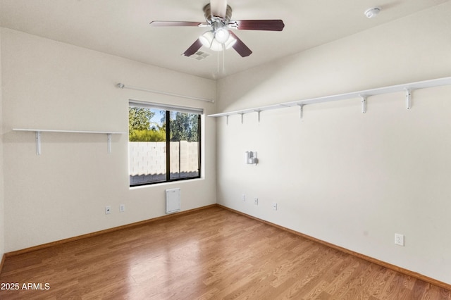 empty room featuring ceiling fan and hardwood / wood-style floors