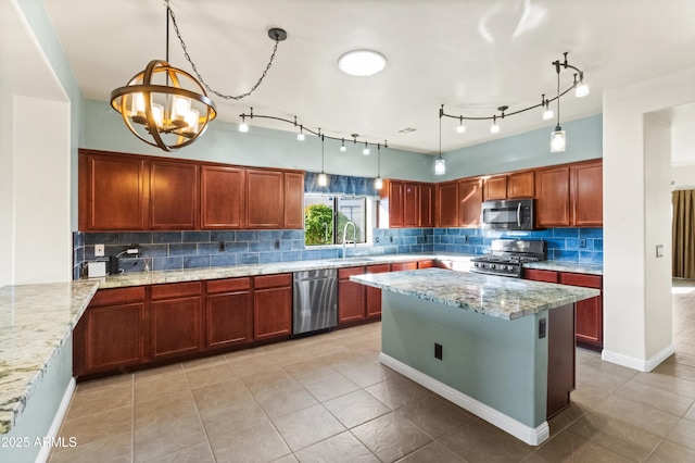 kitchen featuring pendant lighting, sink, an inviting chandelier, stainless steel appliances, and light stone counters