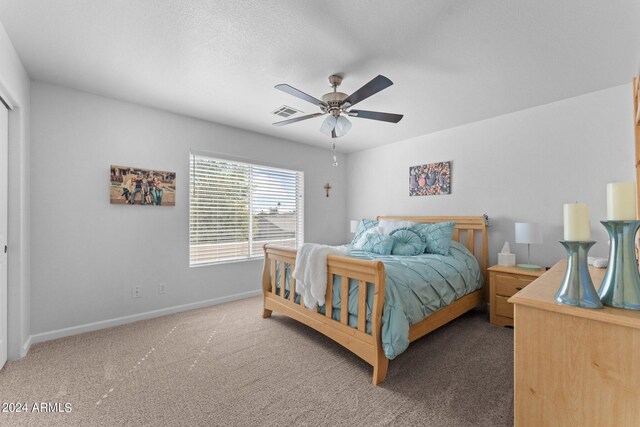 bedroom featuring a textured ceiling, ceiling fan, and carpet flooring