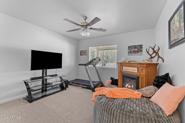 exercise area with ceiling fan and carpet floors