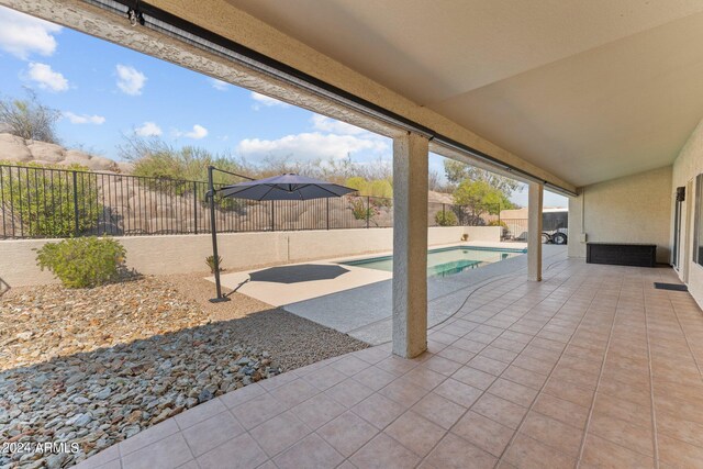 view of patio / terrace with a fenced in pool