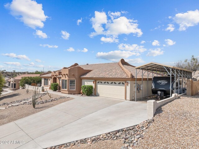 view of front of property with a garage and a carport