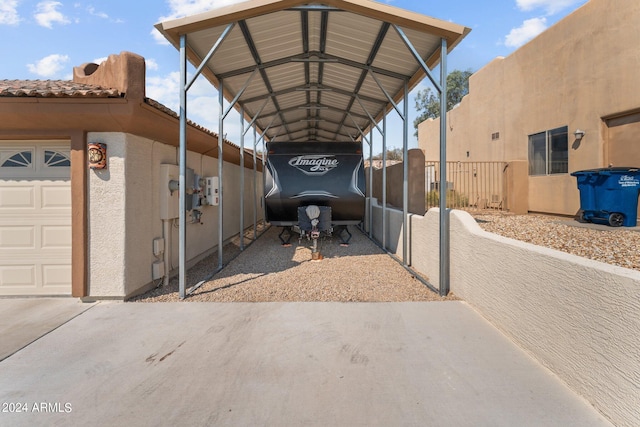 view of parking with a garage and a carport