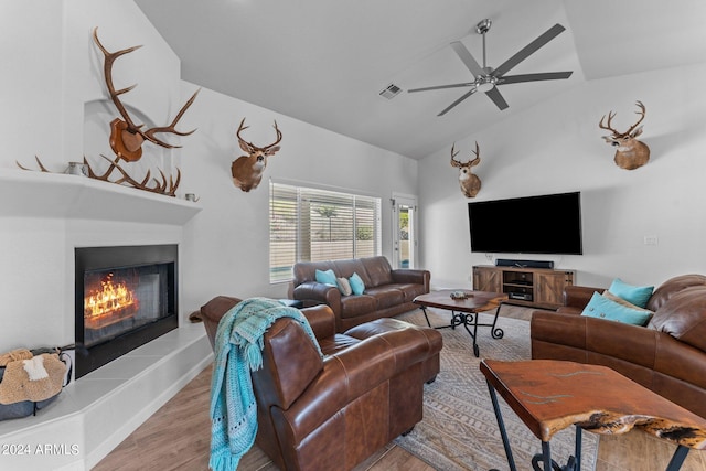 living room featuring lofted ceiling, ceiling fan, and light wood-type flooring