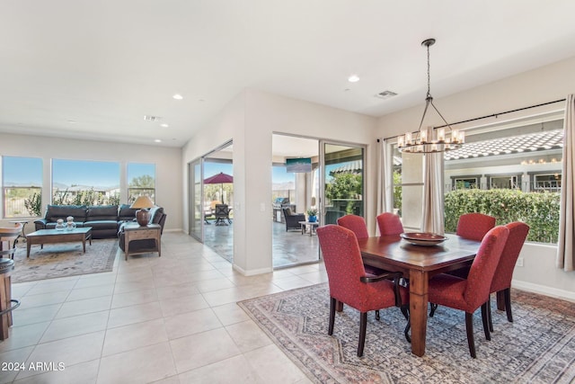 tiled dining space featuring a chandelier