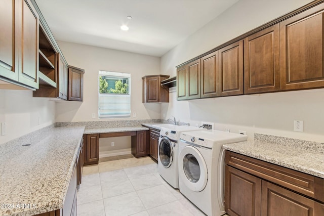 washroom featuring cabinets, light tile patterned floors, washer and dryer, and sink