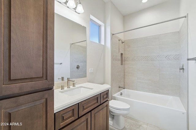 full bathroom with tile patterned flooring, vanity, toilet, and tiled shower / bath