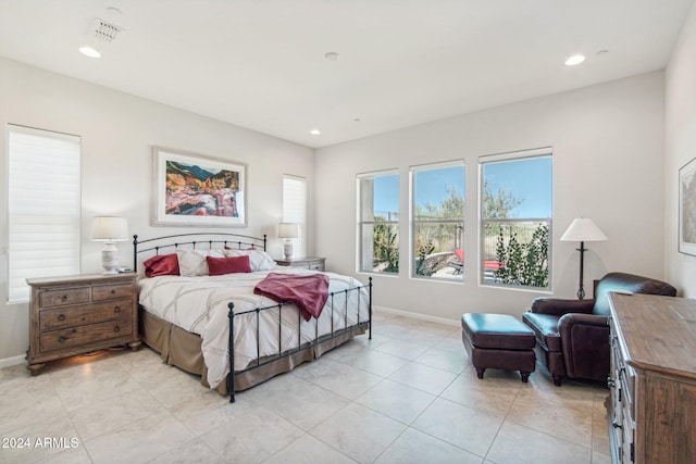 bedroom with light tile patterned floors