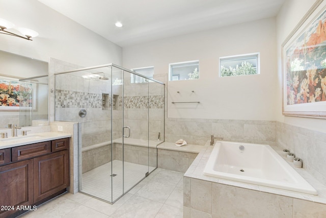 bathroom featuring tile patterned flooring, vanity, and separate shower and tub