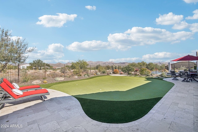 view of property's community featuring a mountain view and a patio area