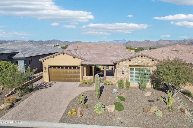 ranch-style house featuring a mountain view and a garage