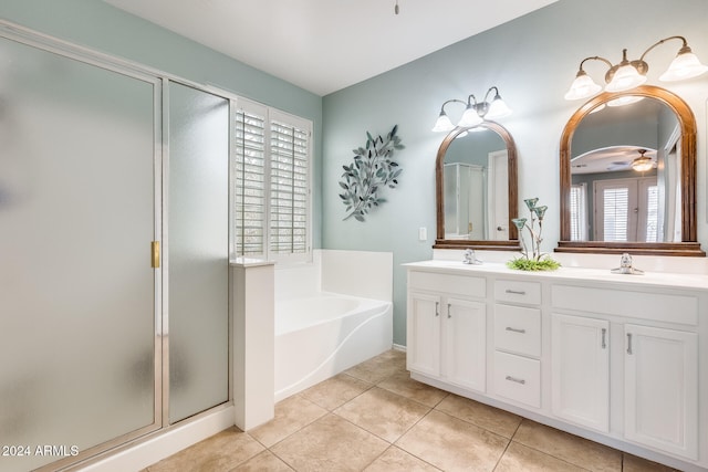 bathroom with tile patterned flooring, vanity, and separate shower and tub