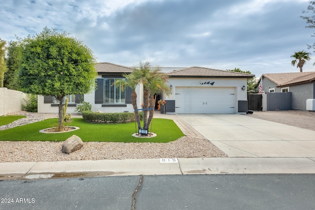 view of front of home featuring a garage and a front yard