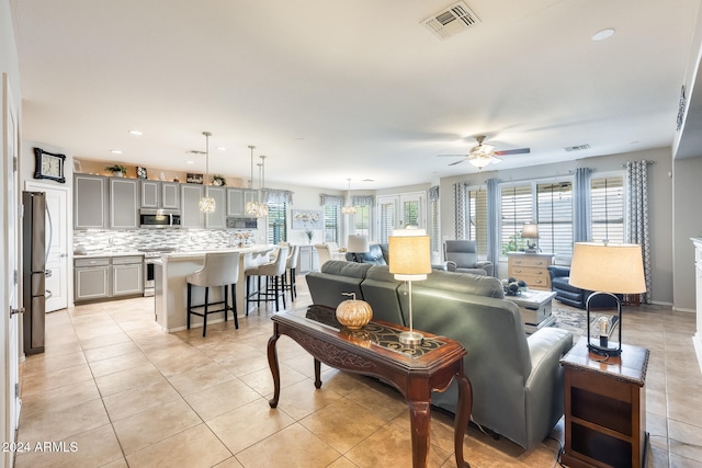 living room featuring ceiling fan and light tile patterned flooring