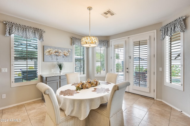 dining area featuring light tile patterned floors and plenty of natural light