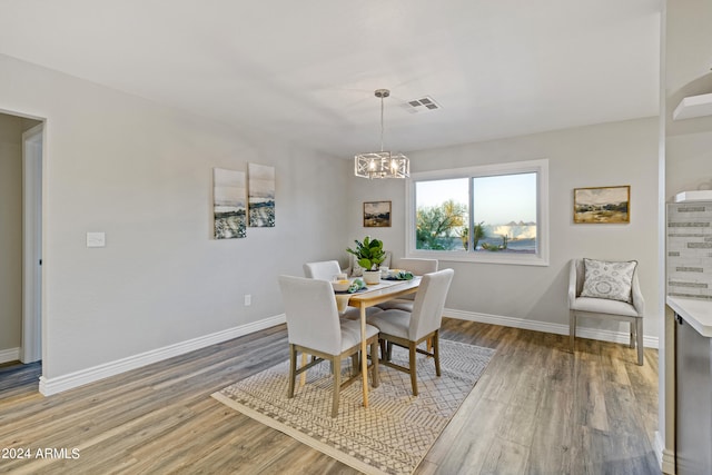 dining space featuring a chandelier and hardwood / wood-style floors