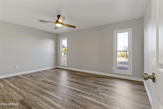 empty room with wood-type flooring and ceiling fan