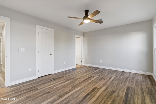 unfurnished bedroom with ceiling fan and dark hardwood / wood-style floors