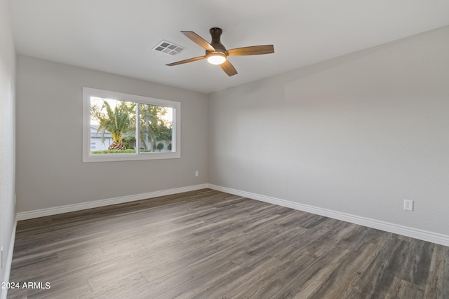 unfurnished room featuring dark hardwood / wood-style floors and ceiling fan