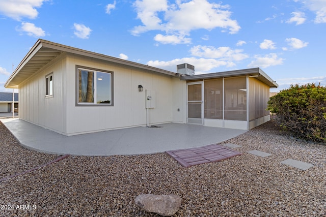 back of house featuring a sunroom and a patio area