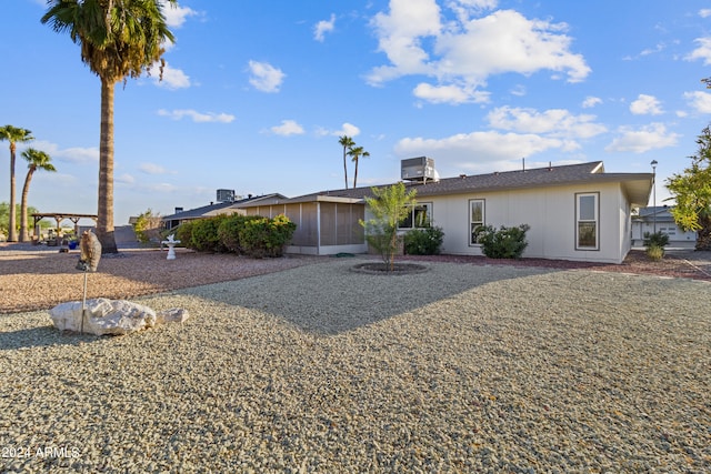 view of front of property with a sunroom and central AC