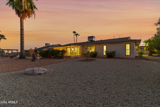 view of front facade featuring a patio and central air condition unit