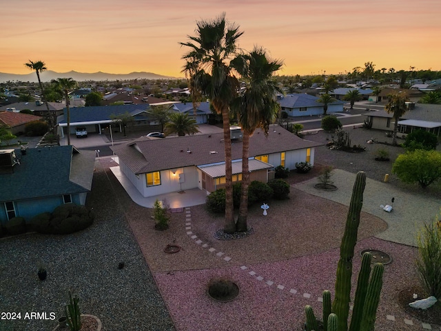 aerial view at dusk featuring a mountain view