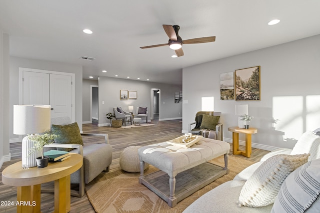 living room featuring light wood-type flooring and ceiling fan