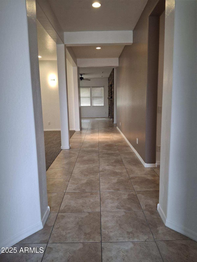 hall with baseboards, recessed lighting, and tile patterned floors
