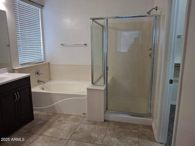 bathroom with a garden tub, vanity, tile patterned flooring, and a stall shower